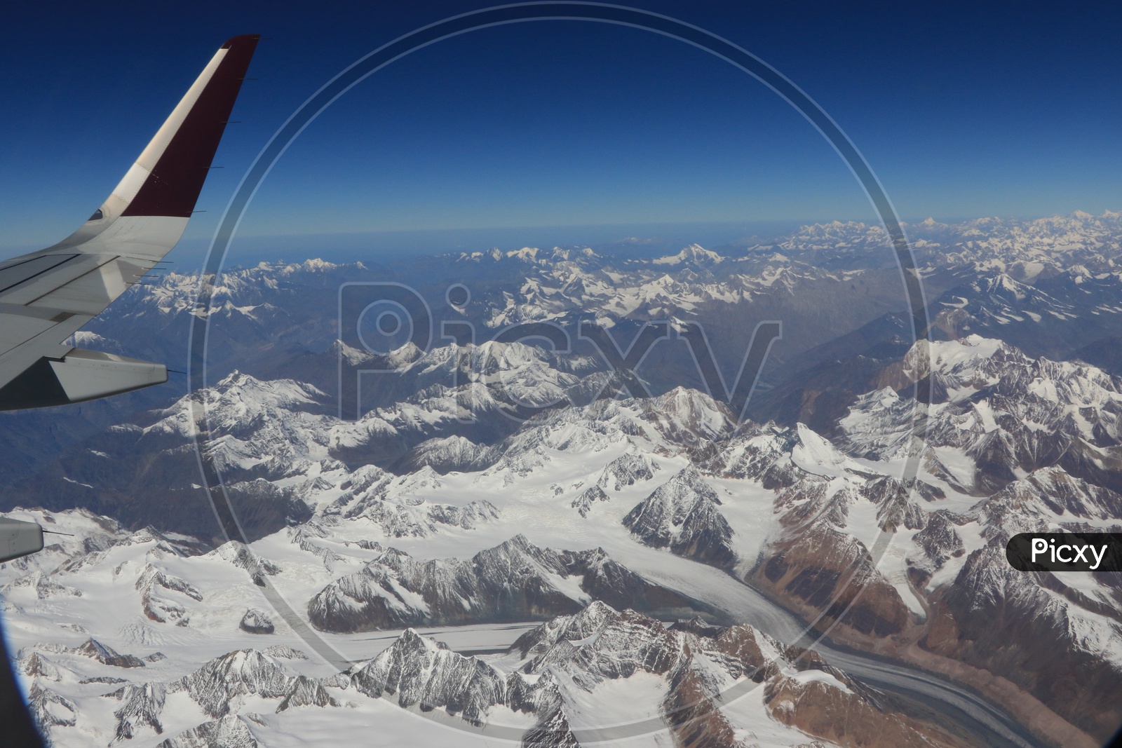 Beautiful snow-capped mountains of leh captured from flight window