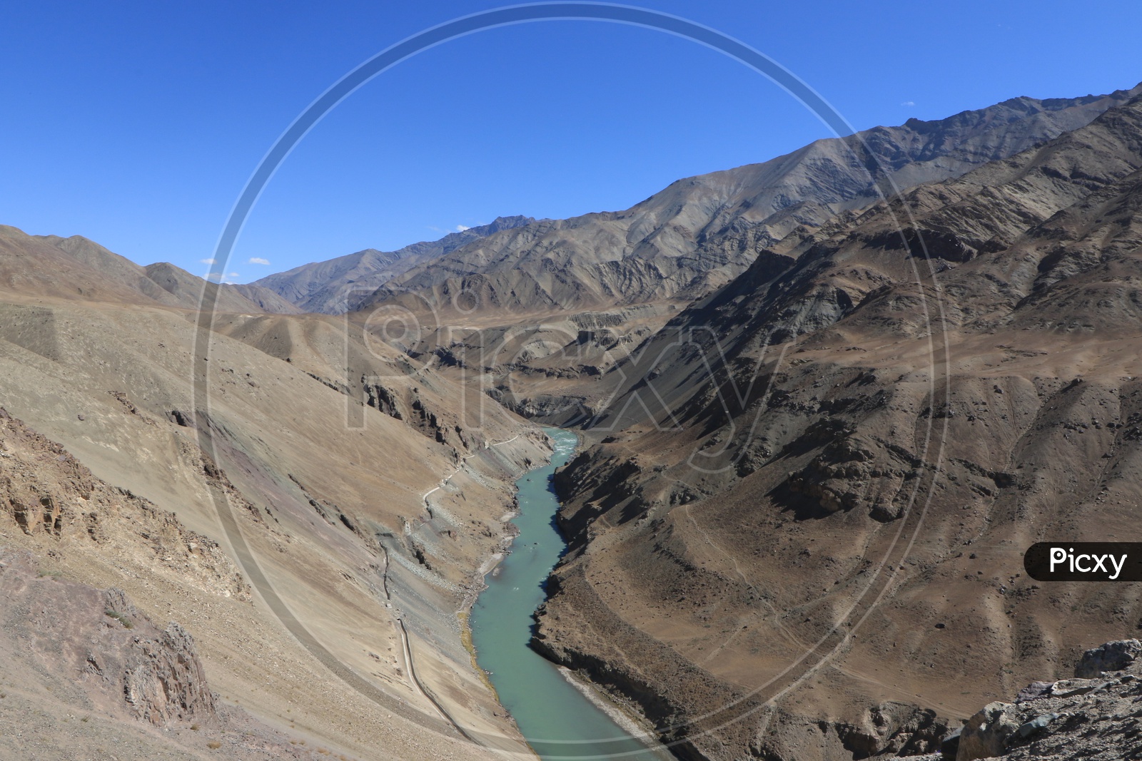 river passes through the dusty mountains in leh