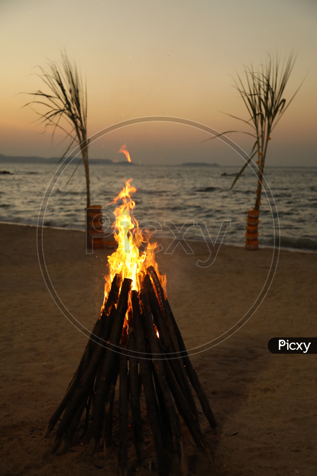 Beautiful campfire with beach in the background