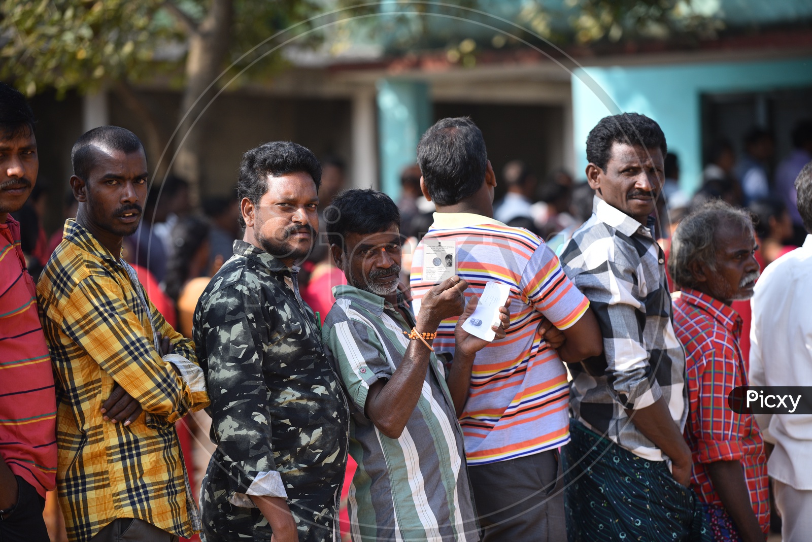 People standing in queue to use their vote