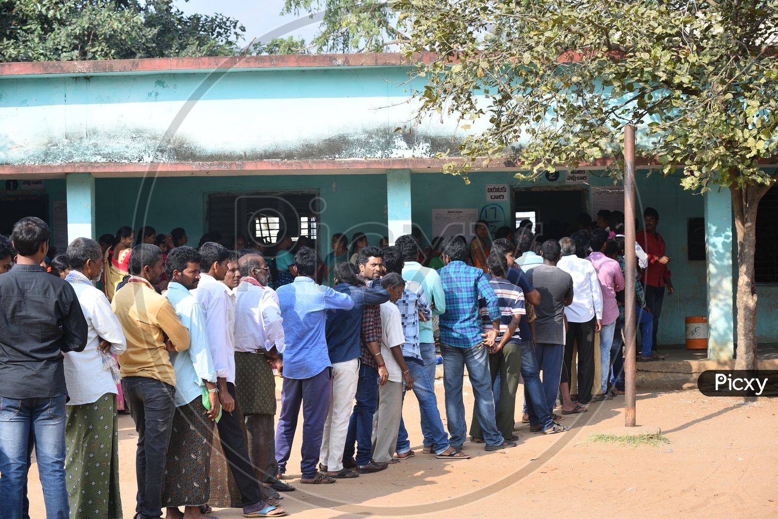 People standing in queue at poll booth to use their vote