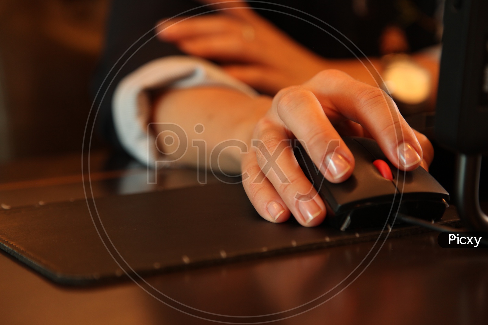 Close up shot of hands using mouse