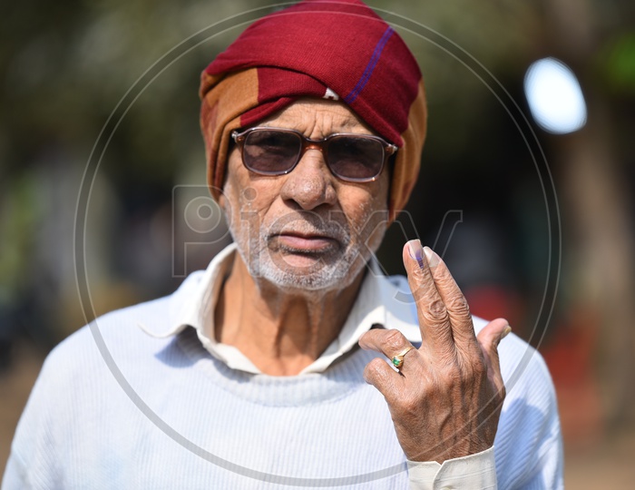 Portrait of Old man showing his voted finger