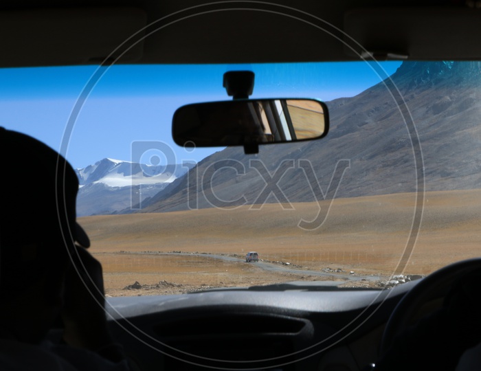 Beautiful snow-capped mountains of Leh captured from moving car