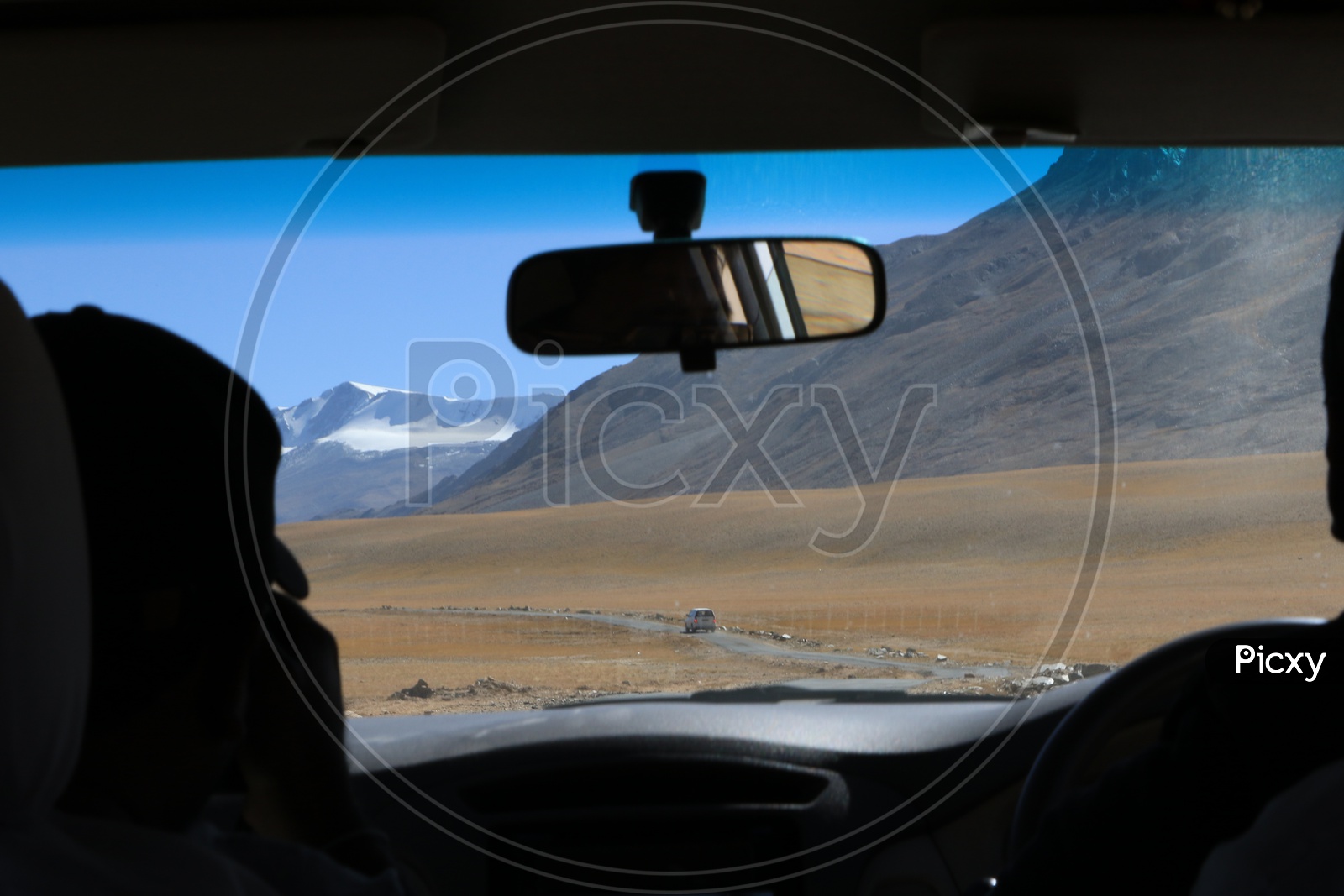 Beautiful snow-capped mountains of Leh captured from moving car