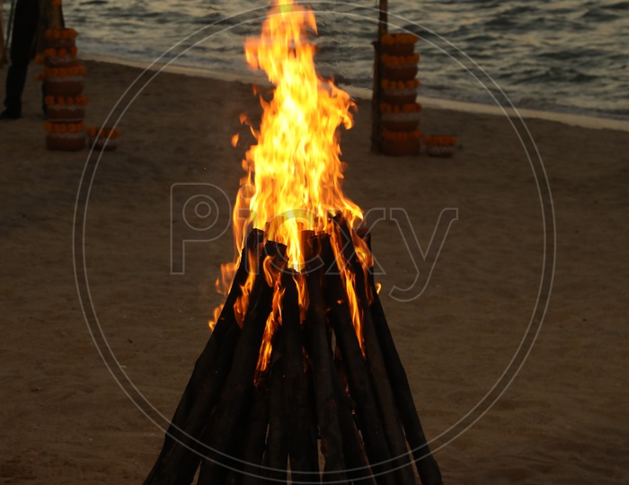 Beautiful campfire with the beach in the background