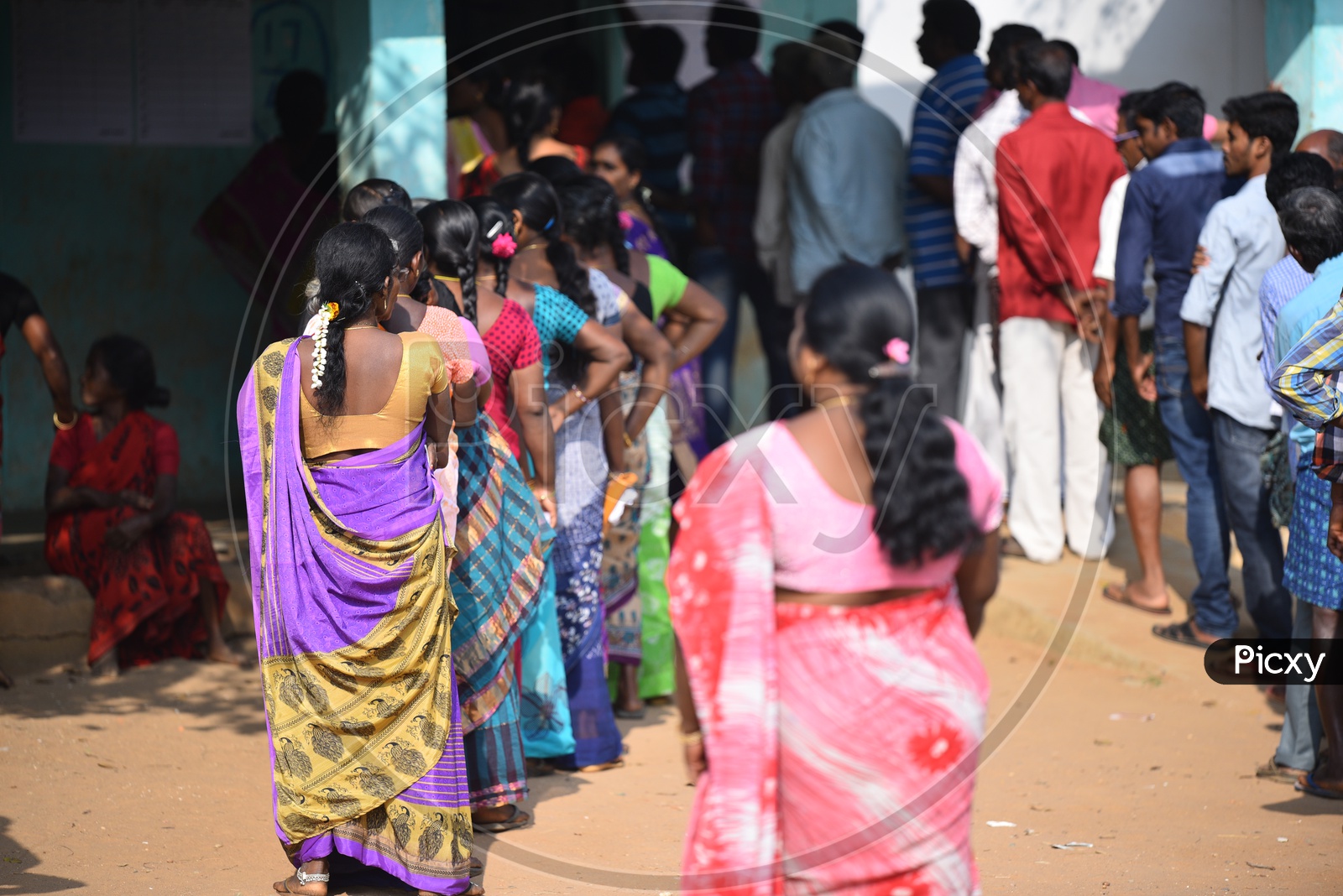 People standing in queue to use their vote