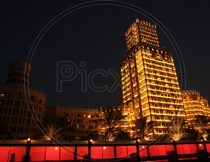 High Rise Buildings With Luminous Lights In Night Time