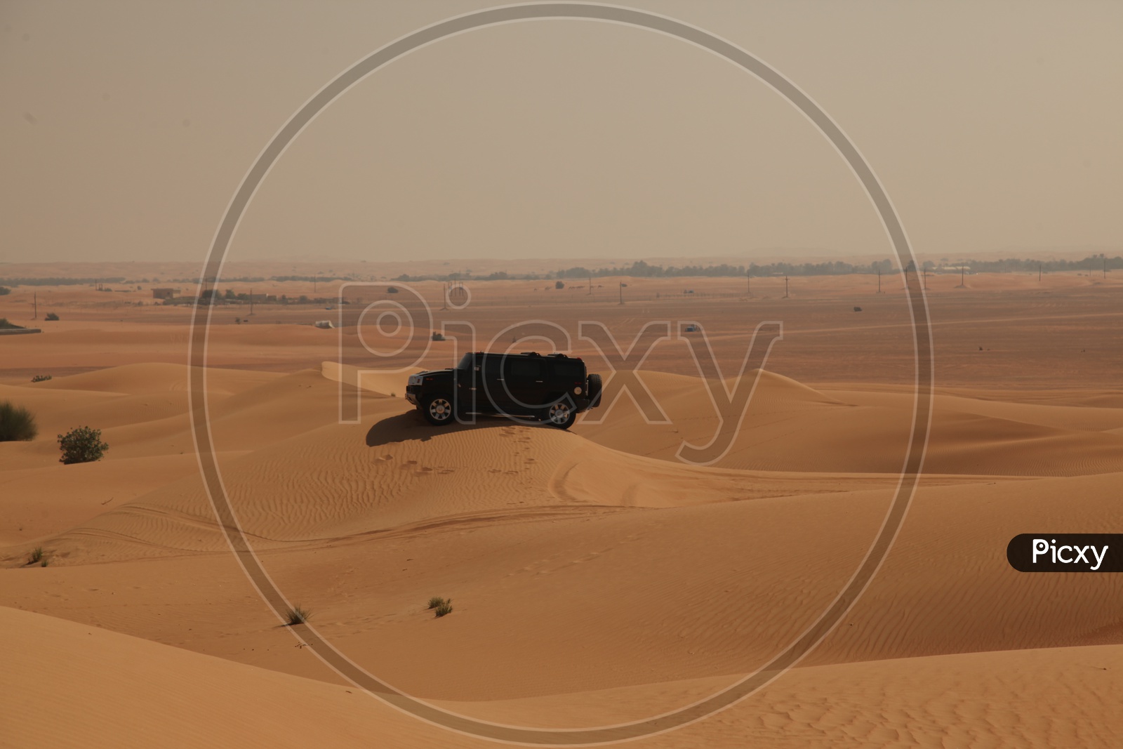 A black Jeep in the sand dunes
