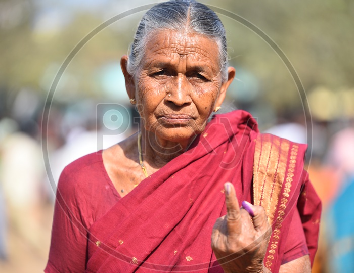 Indian old women showing her voted finger