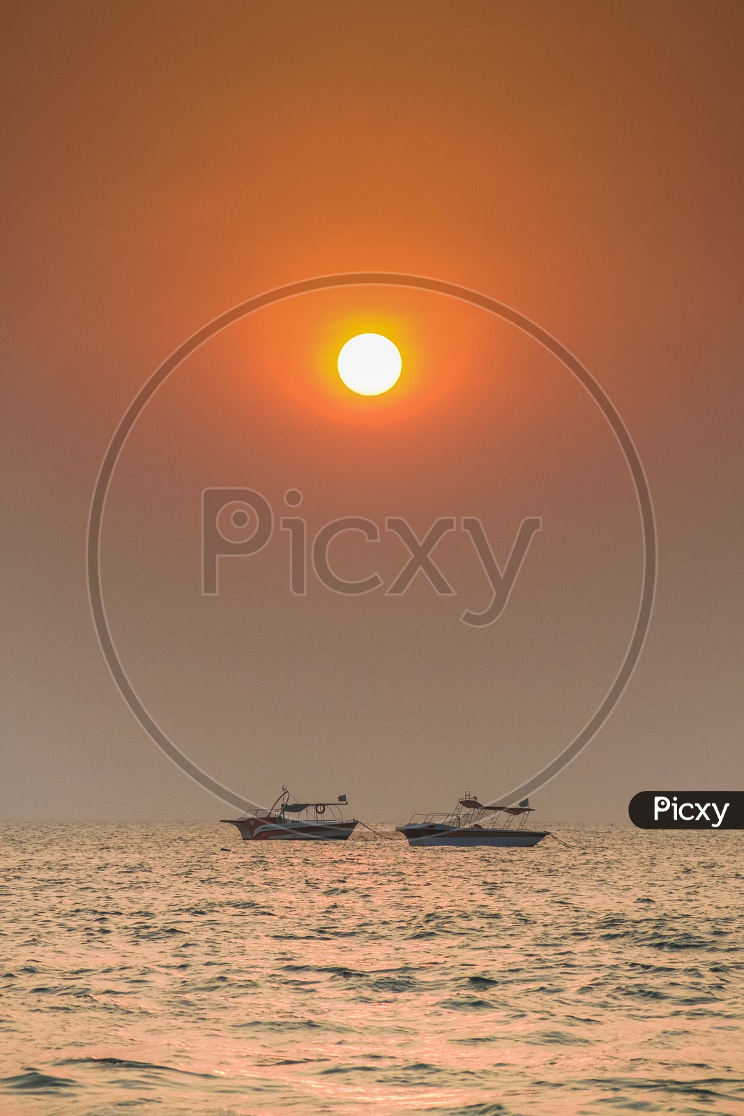 Sunrise over the beach - boats at a distance