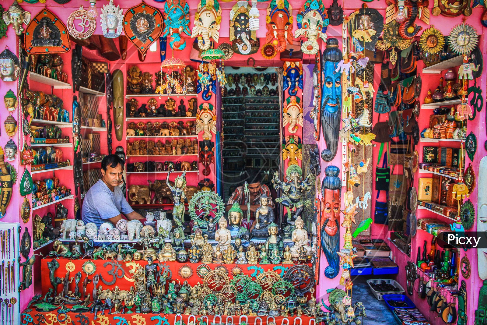 A shop with decorative items and a seller in it