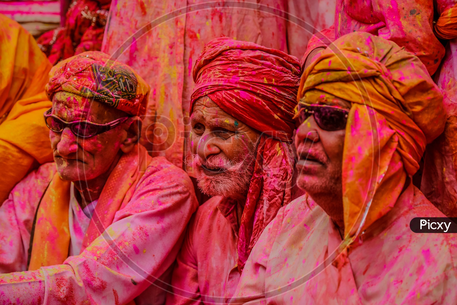 People with coloured face in the streets of Barsana