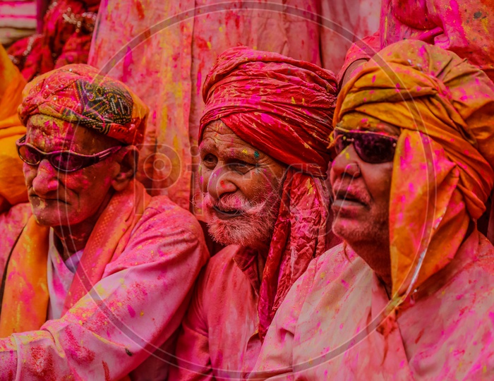 People with coloured face in the streets of Barsana