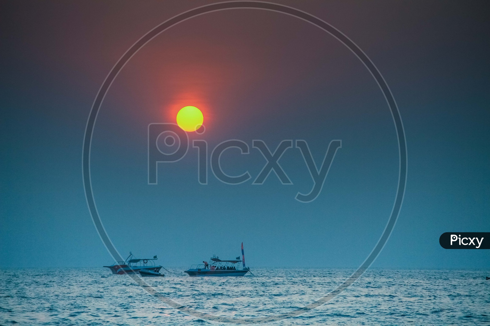 Beautiful sunset view with boats sailing in the foreground