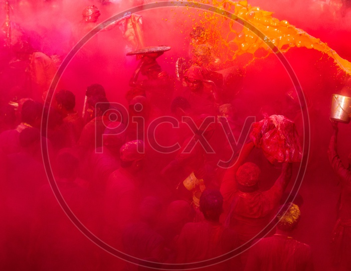 People celebrate the traditional and a ritualistic Holi at Radharani temple