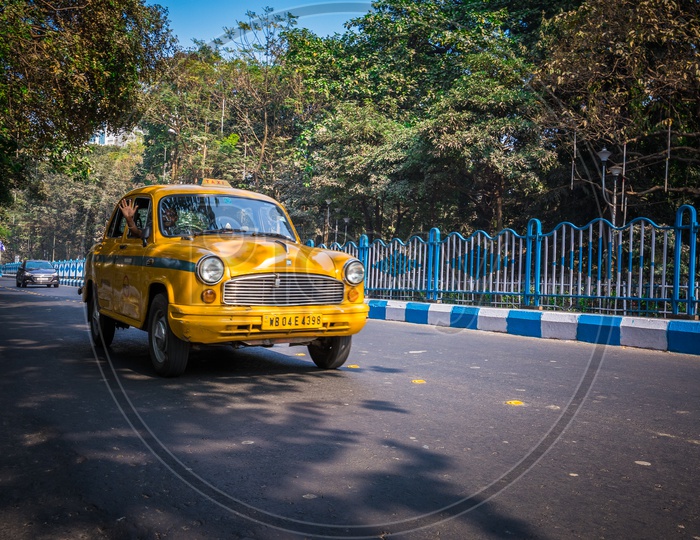Yellow Taxi moving on the roads of Kolkata