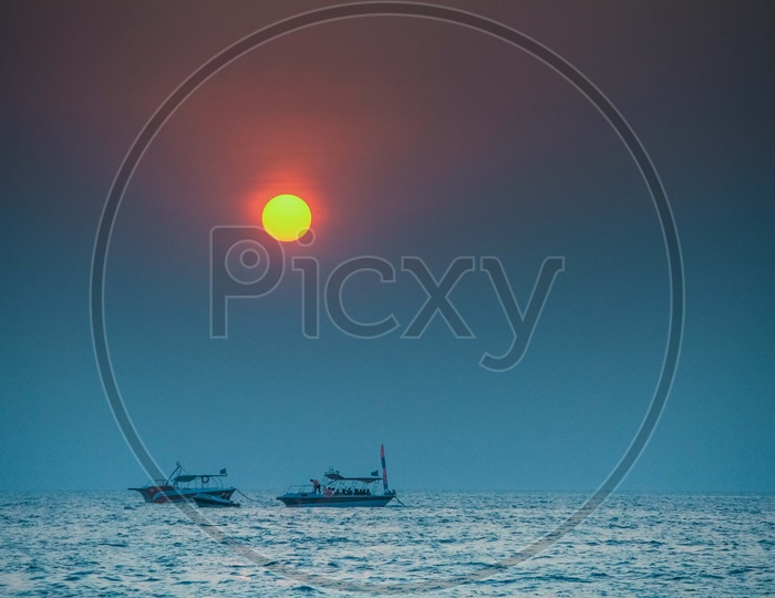 Beautiful sunset view with boats sailing in the foreground
