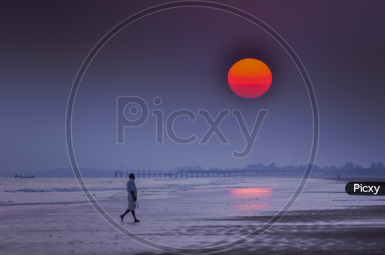 A man walking during Sunrise along the beach - Surya Lanka