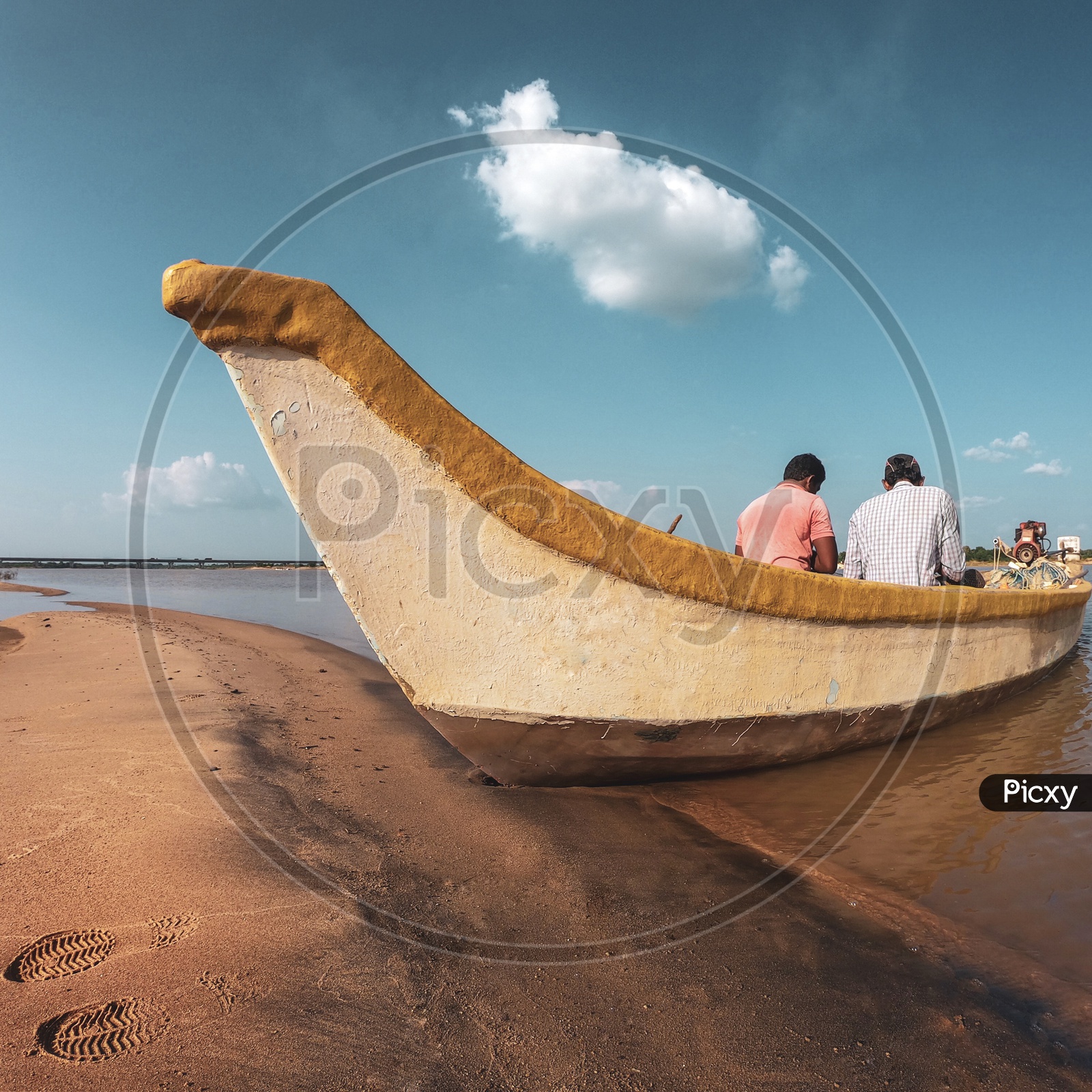 Image of Two men sitting in the boat-DU940796-Picxy