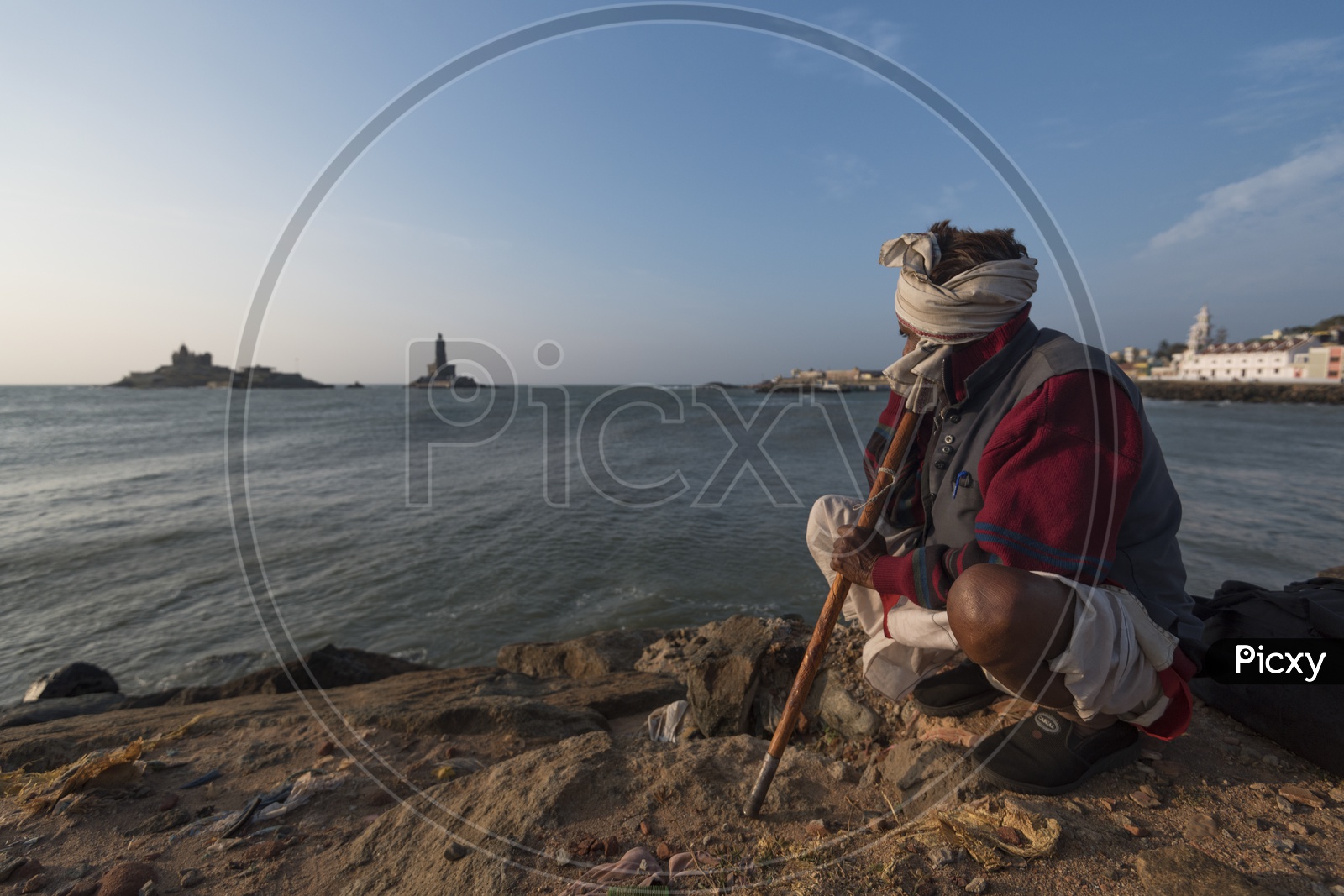 A man in Indian traditional attire at the beach