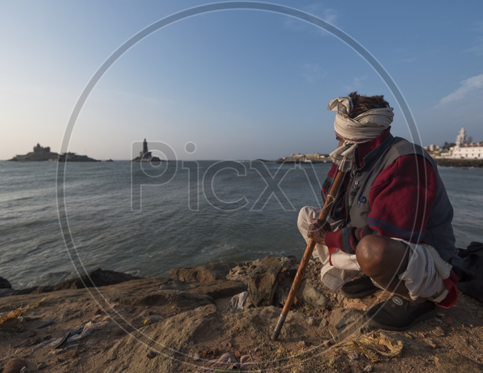 A man in Indian traditional attire at the beach