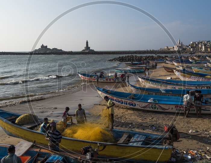 Fishermen setting up the fishing net on a boat at a Beach