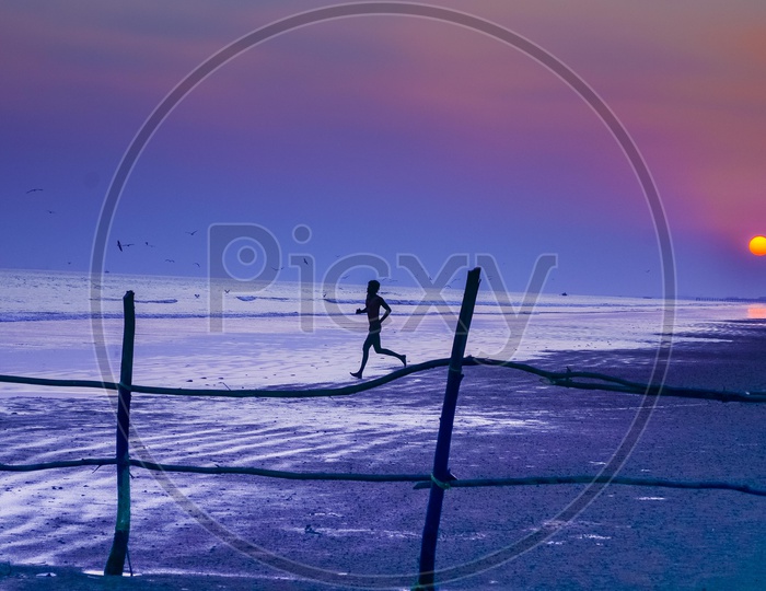 A man at Sunrise along the beach - Surya Lanka