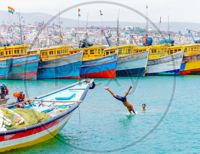 A man diving into the sea at a harbour
