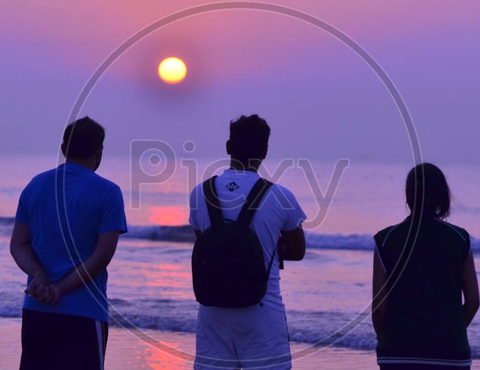 People at Sunrise along the beach - Surya Lanka