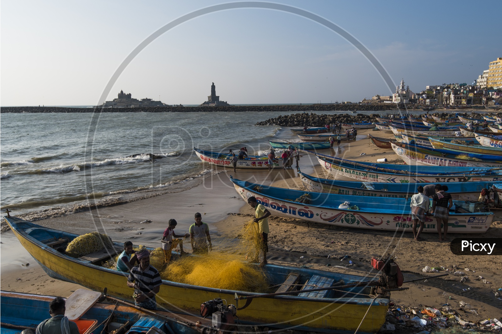 Fishermen setting up the fishing net on a boat at a Beach