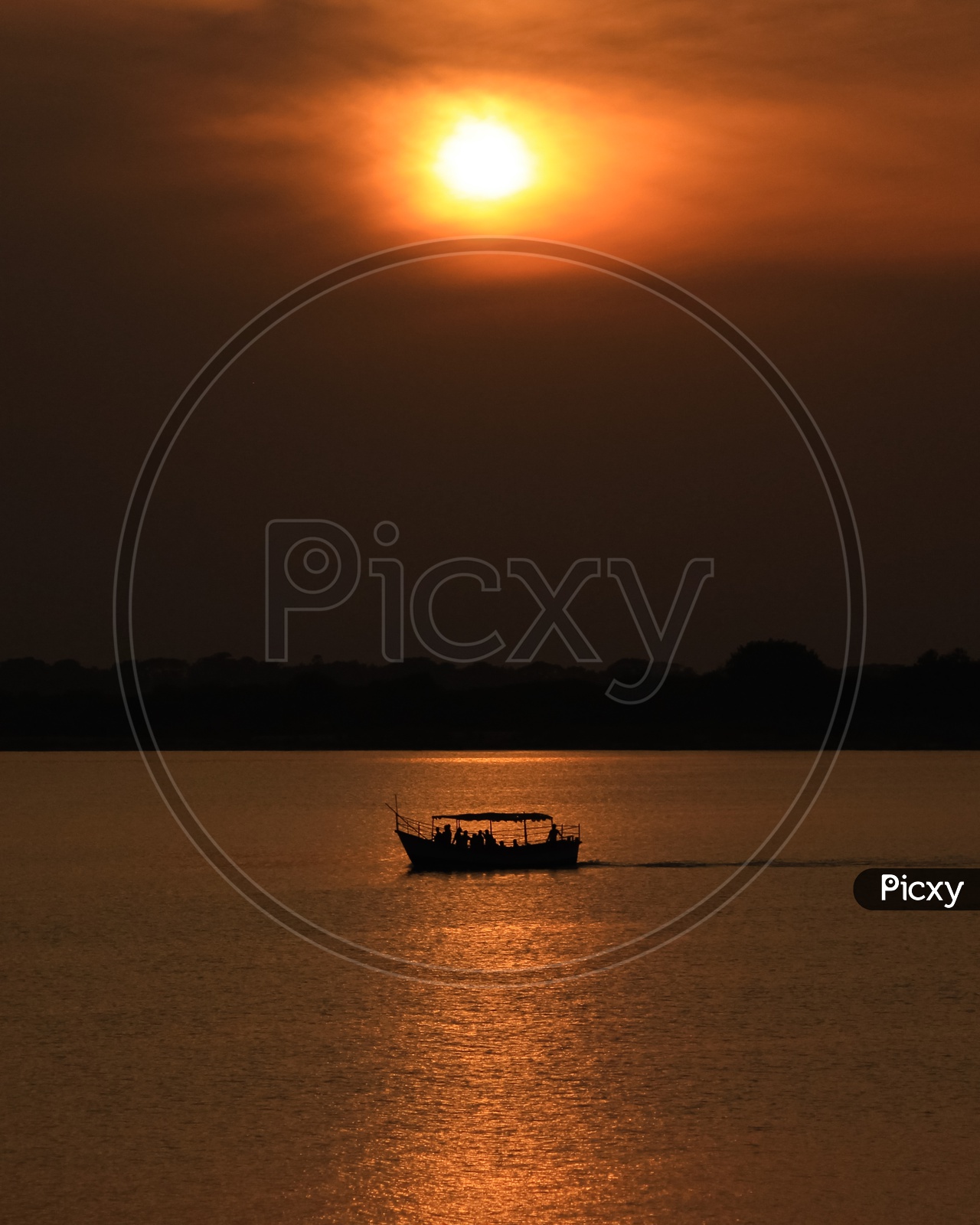Man standing on a boat at Rajahmundry during sunrise