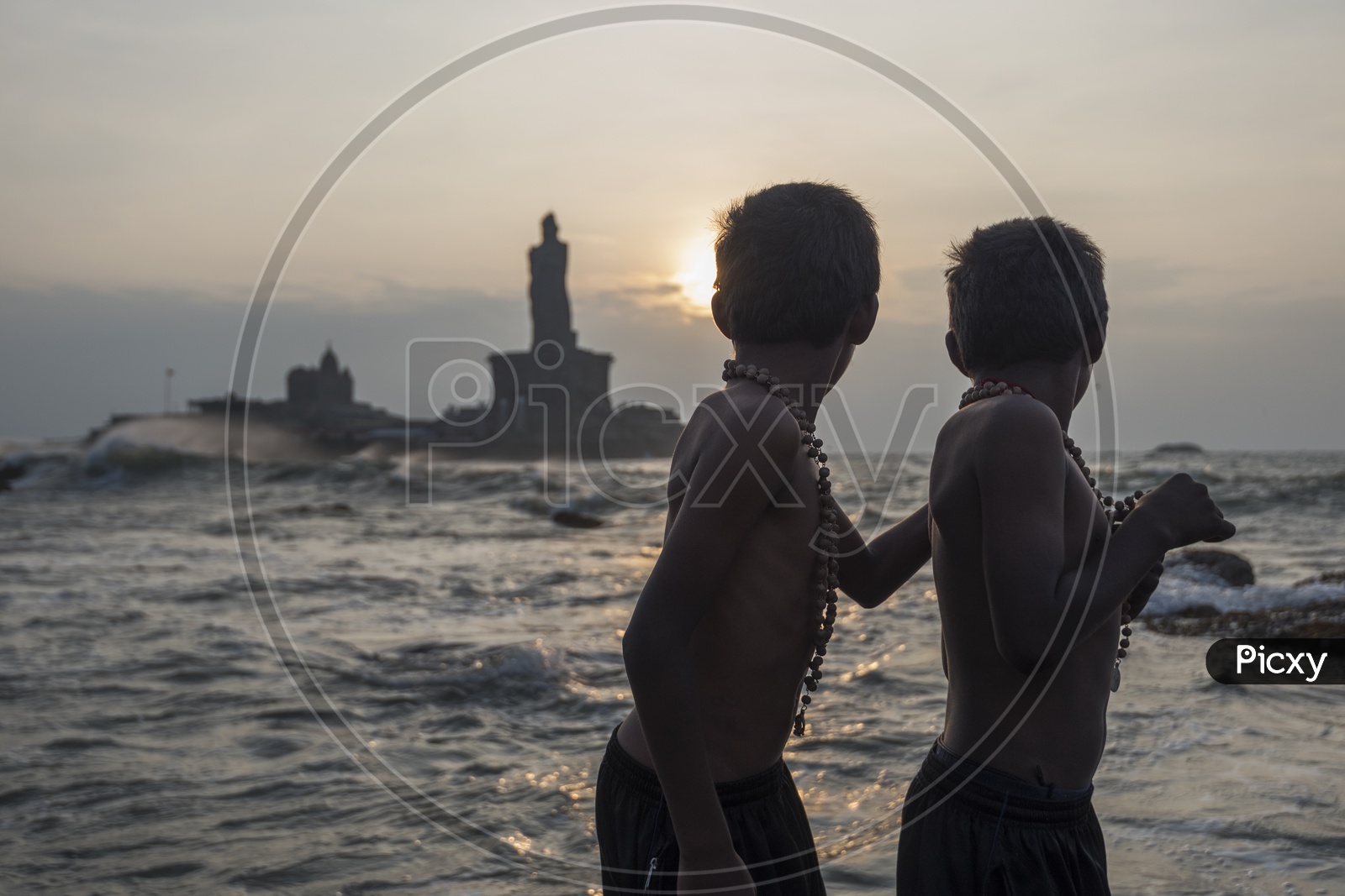 Two young boys in Sabarimala maala at the beach in Kanyakumari