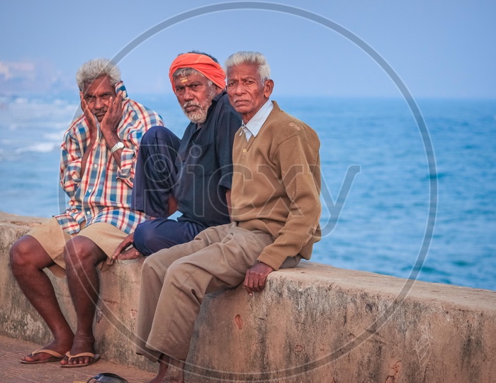 Old men sitting at a beach