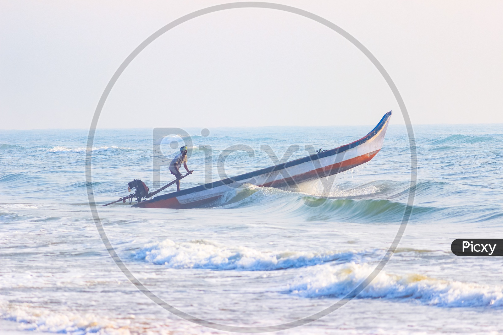 A man sailing in a boat against waves in sea