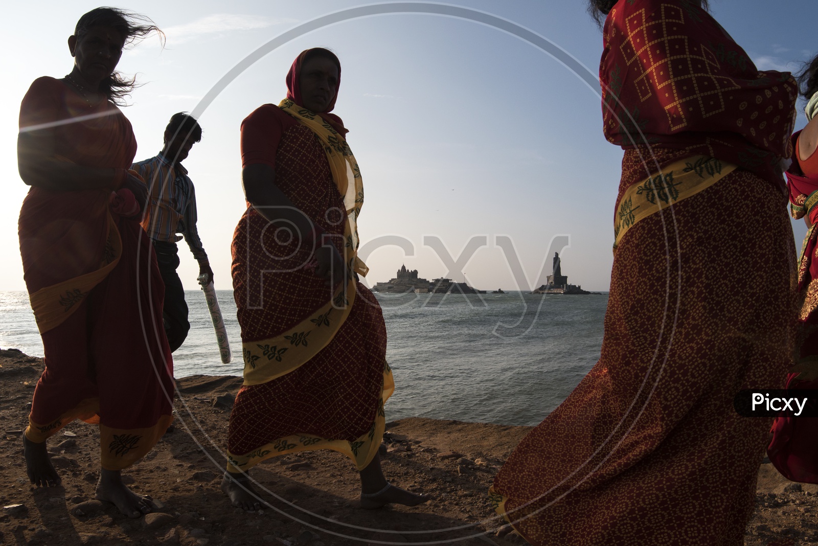 Women walking along the sea shore