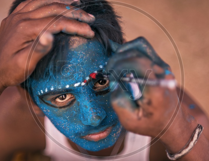 A boy having makeup for Festival of Kali Kaveripattinam
