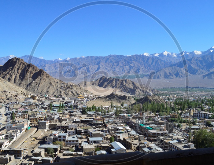 Beautiful snow-capped mountains of leh with leh village in the foreground