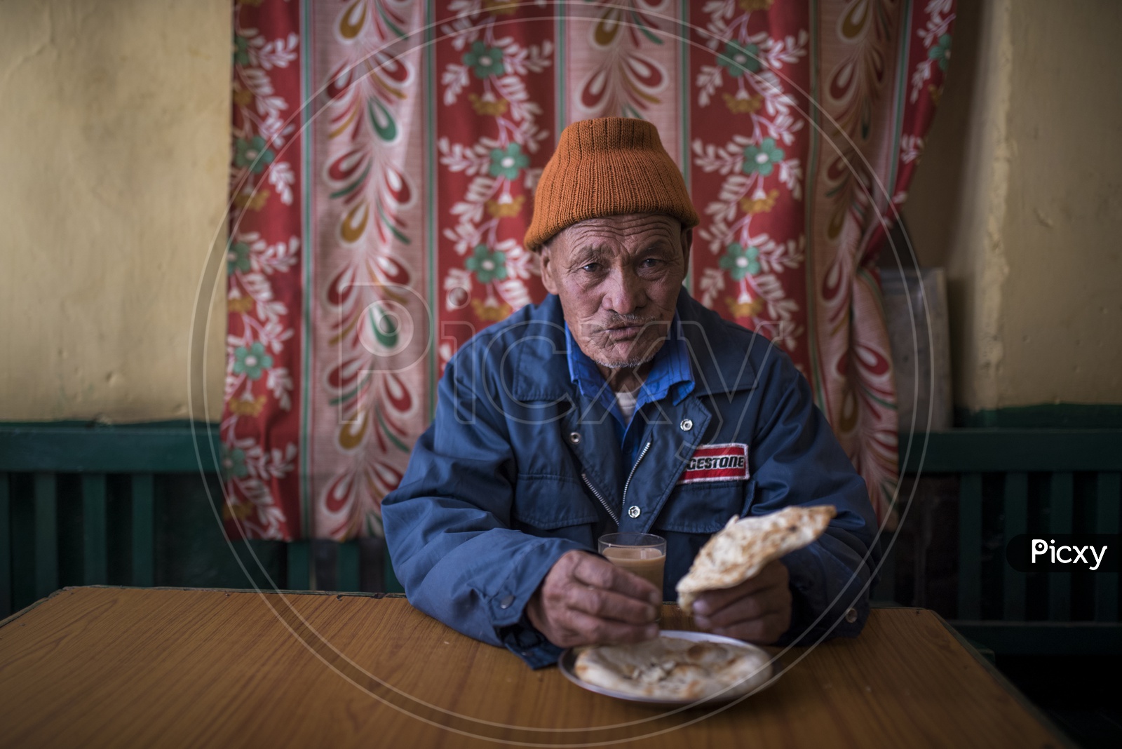Kashmiri Old man Eating Paratha in a Hotel