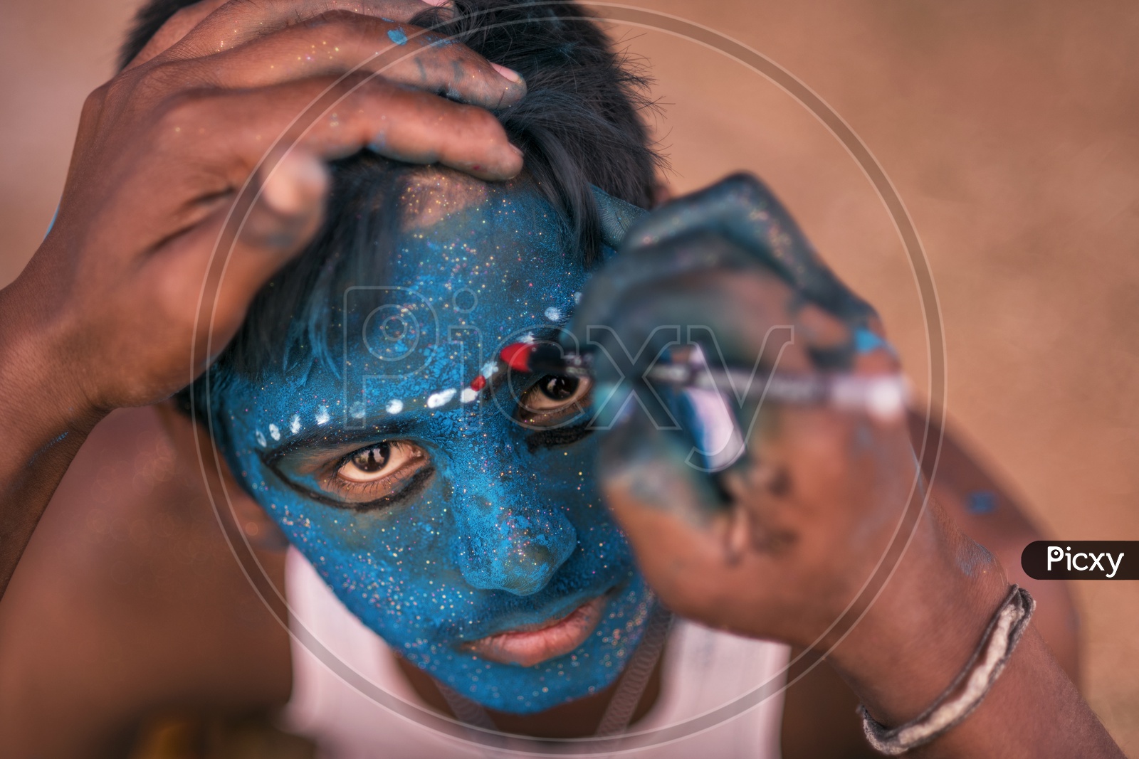 A boy having makeup for Festival of Kali Kaveripattinam