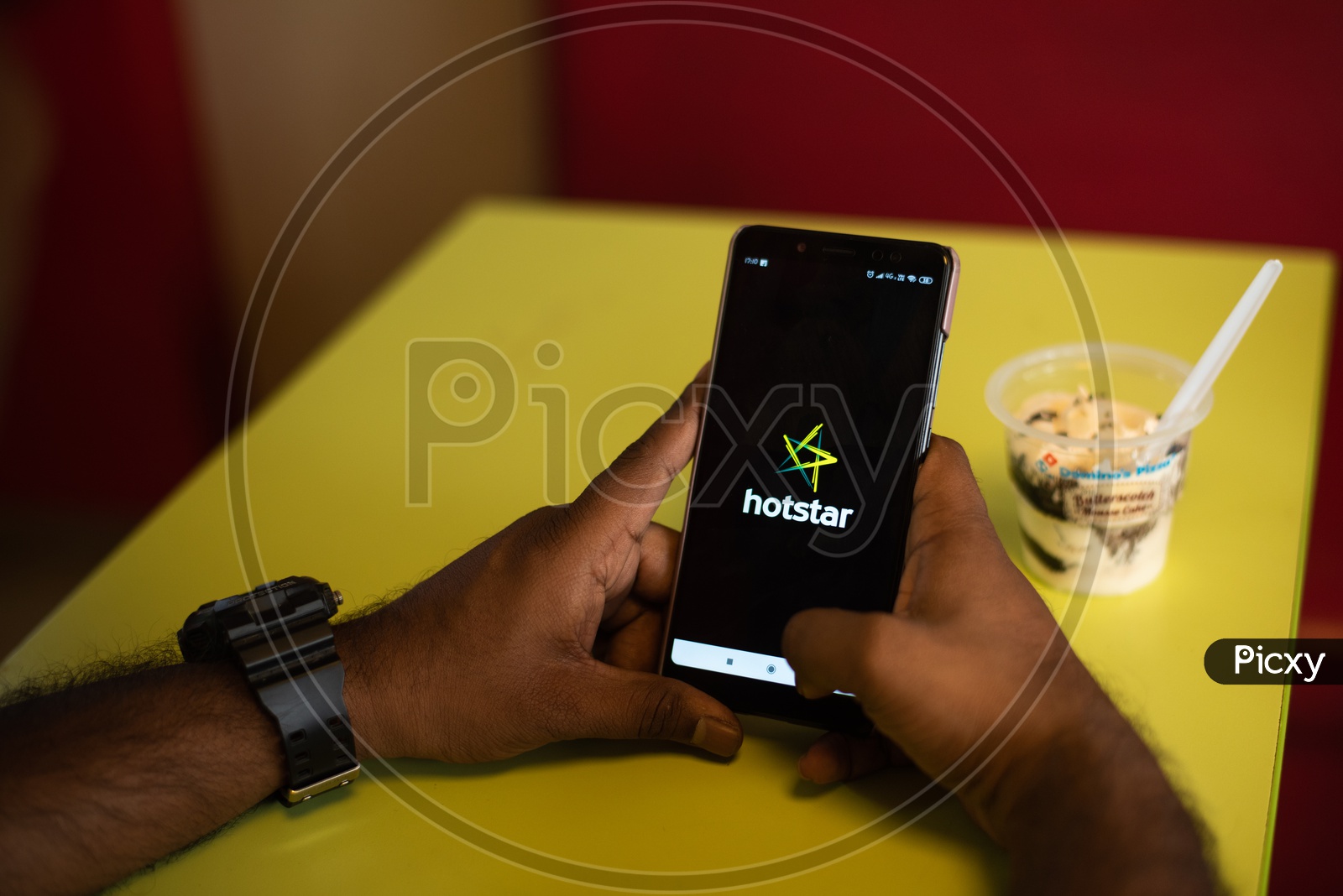 Indian youth using Hotstar Online streaming App in Mobile Phone