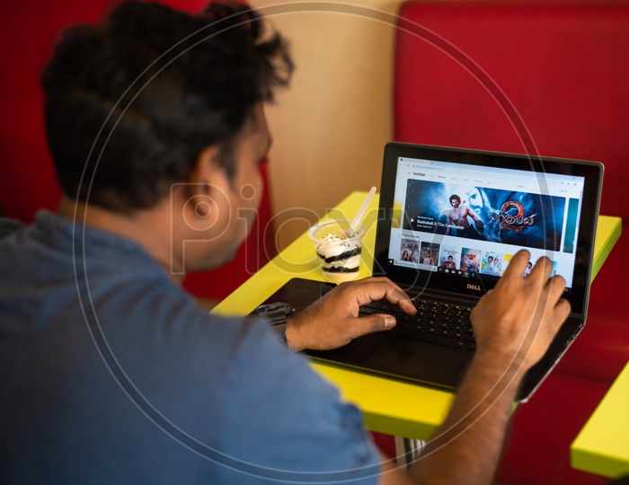 Indian youth using Hotstar Online streaming website on a Laptop / PC