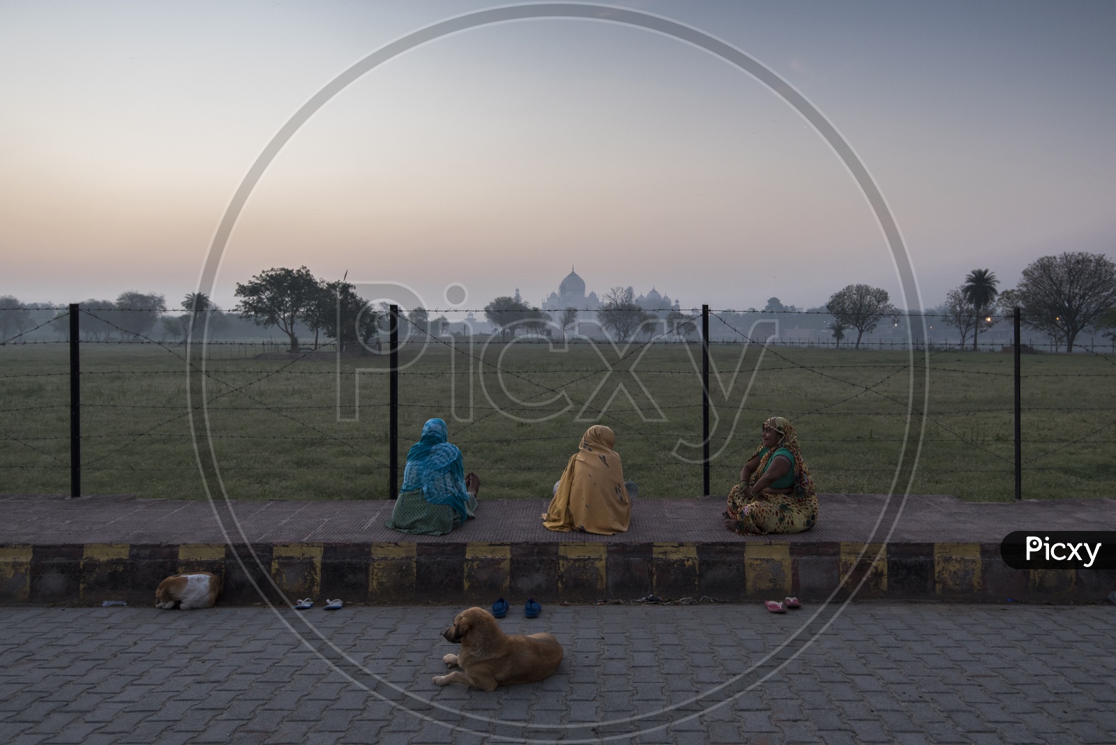 Women sat on Footpath enjoying the view of Taj Mahal