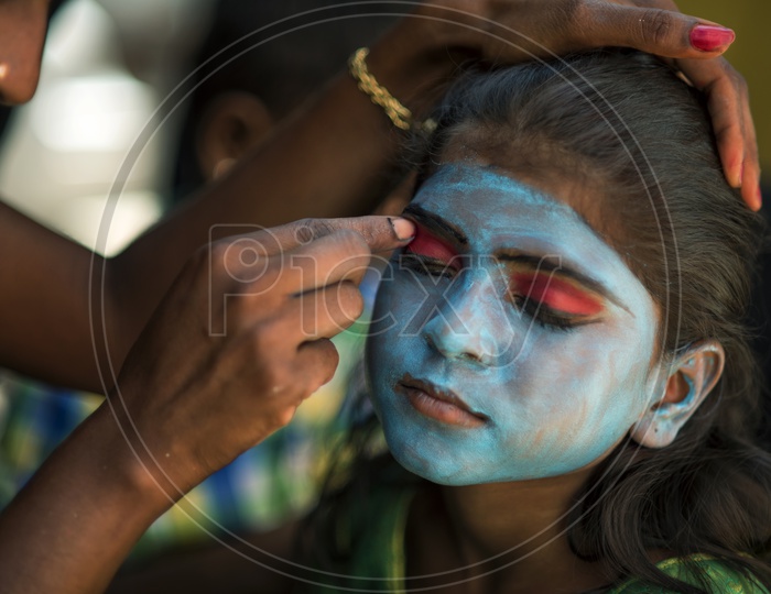 A girl having her makeup for Festival of Kali Kaveripattinam