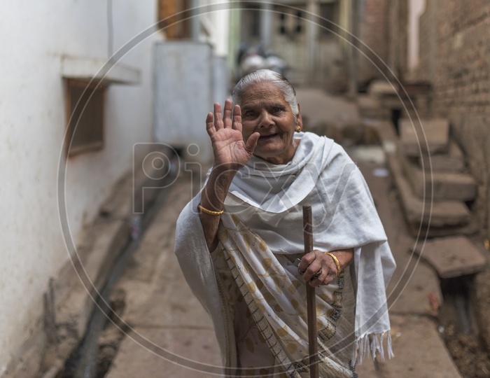 Old Woman in Agra Street waving Hand