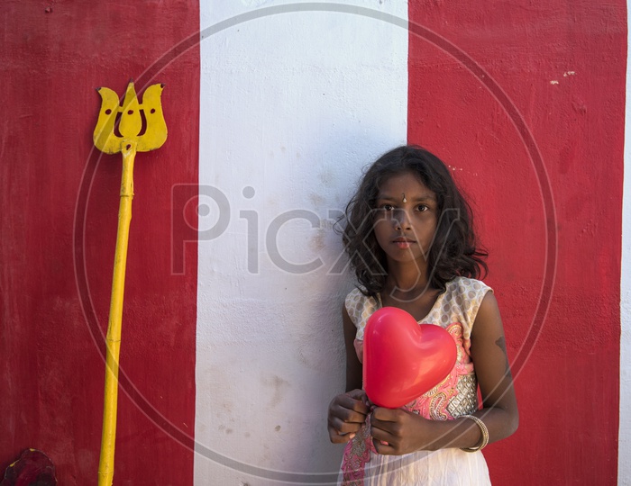 Portrait of a girl holding Heart Shaped Balloon