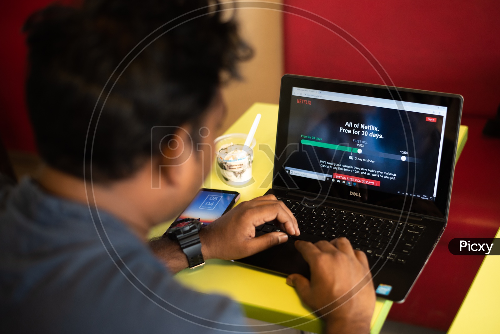 Indian Youth Using Netflix On Laptop