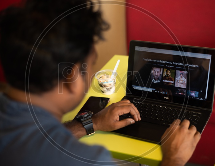 Indian Youth Using Netflix On His laptop