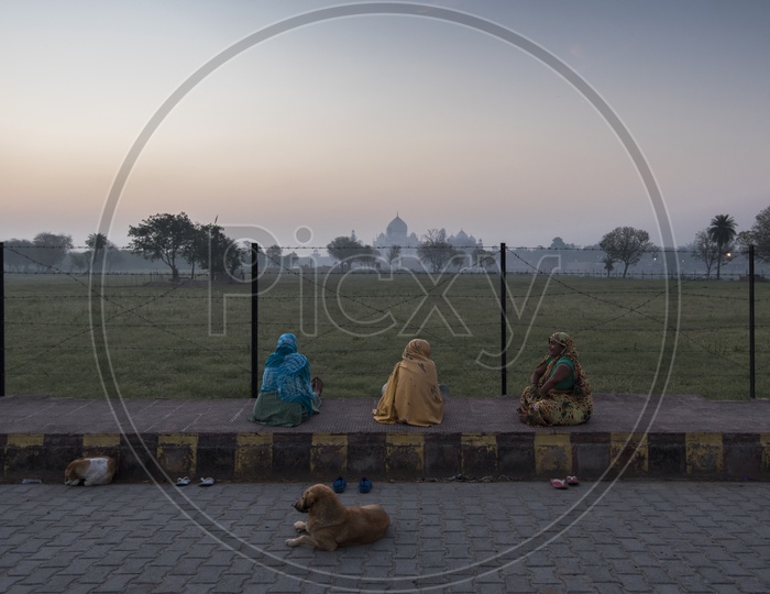 Women sat on Footpath enjoying the view of Taj Mahal