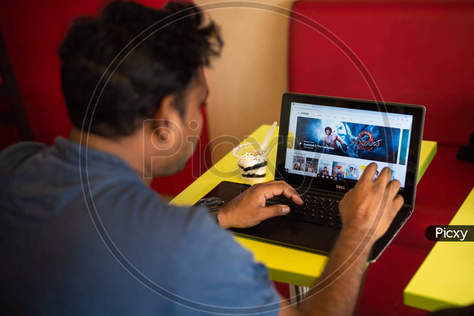 Indian youth using Hotstar Online streaming website on a Laptop / PC